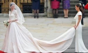 Kate's Wedding Dress Image of Kate Middleton's wedding dress with the trail being held by one of the bridesmaids