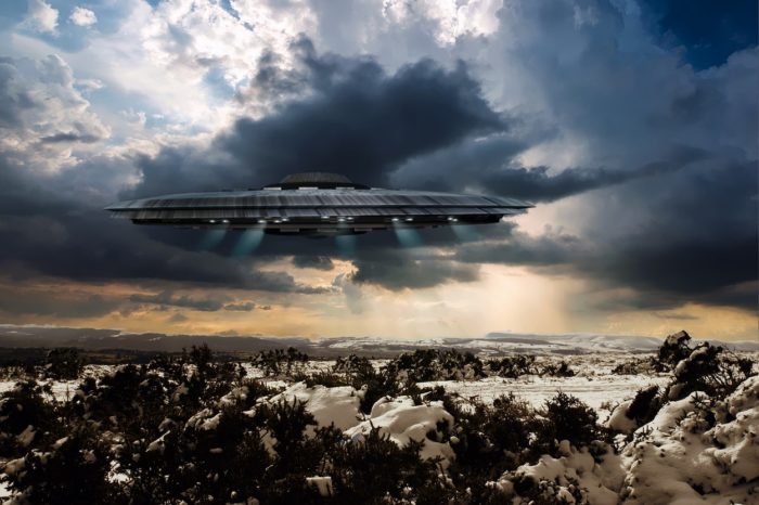 A depiction of a UFO over the countryside