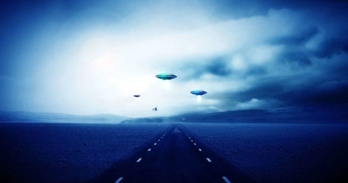 Artist's impression of an alien abduction over a road.