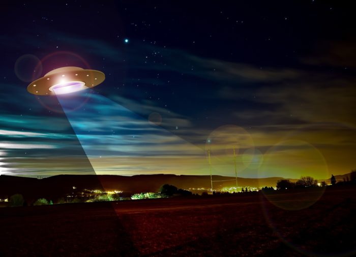 Artist's impression of a UFO hovering over a field