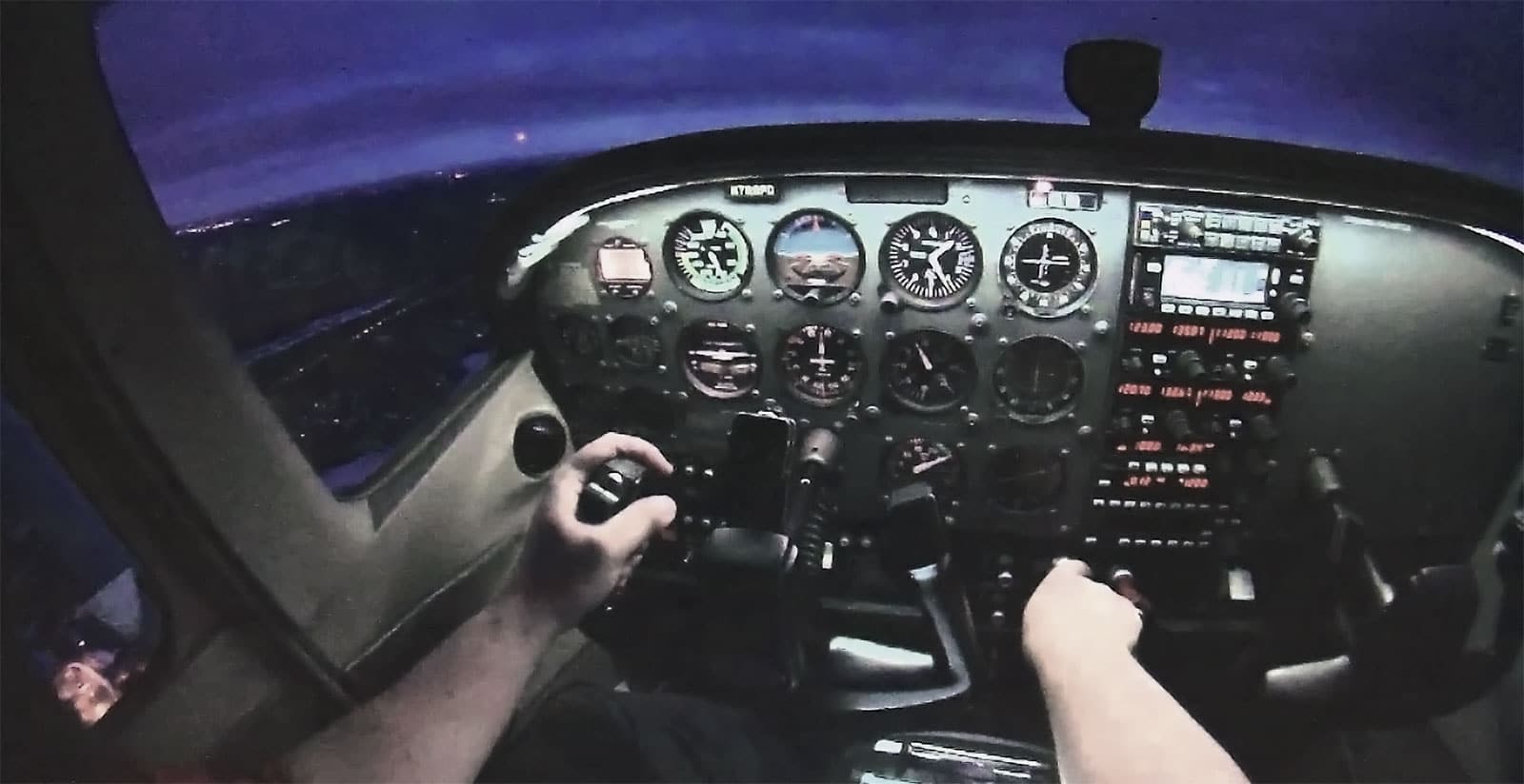 The cockpit of a similar Cessna light aircraft at night.