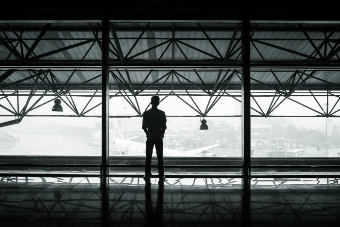 A dark figure looking out from Airport Stranded