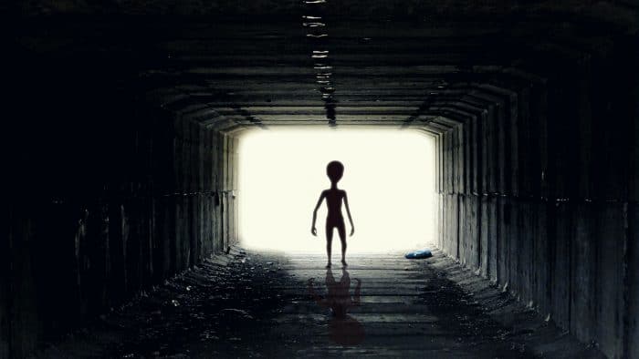 A depiction of an alien in a tunnel