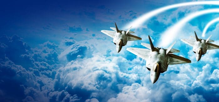 Depiction of three fighter jets in a cloudy sky