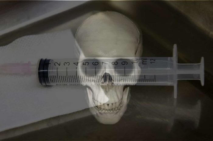 A picture of a medical needle with a skull superimposed underneath