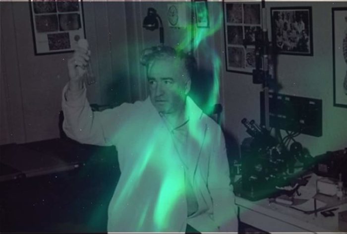 Wilhelm Reich in his lab with a green glow superimposed underneath