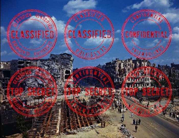 A picture of the ruins of World War Two Berlin with "Classified" stamps superimposed on the top