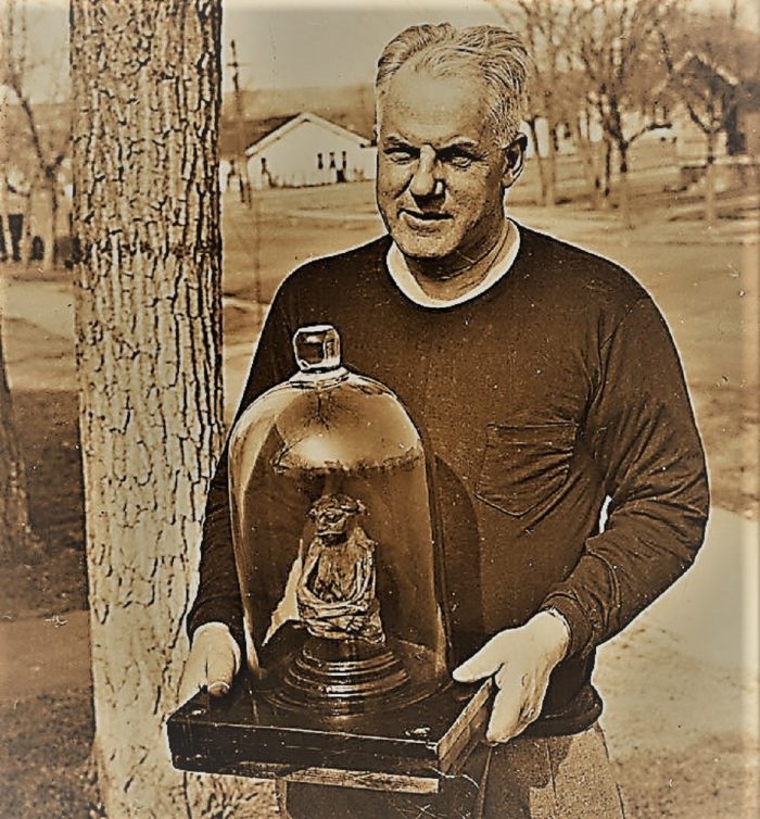 Ivan Goodman holding the The Pedro Mummy in a display jar