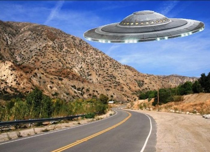 A superimposed UFO on a mountain road