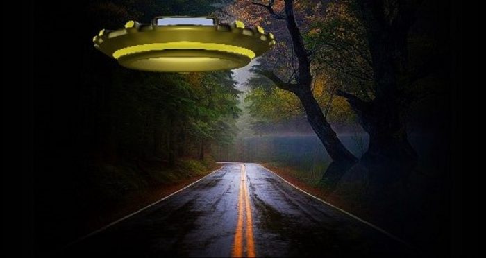 A depiction of a UFO hovering over a quiet road