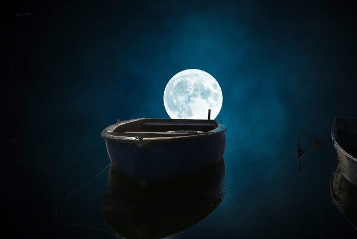 A lone fishing boat on the water under a full moon