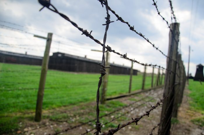 A close-up of the barbed wire fence of a Labor camp