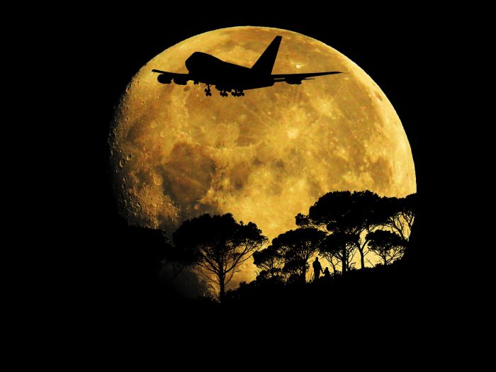 A Jumbo Jet flying across the moon