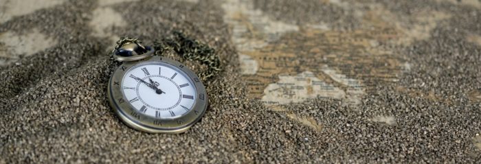 A clock face dropped in the sand