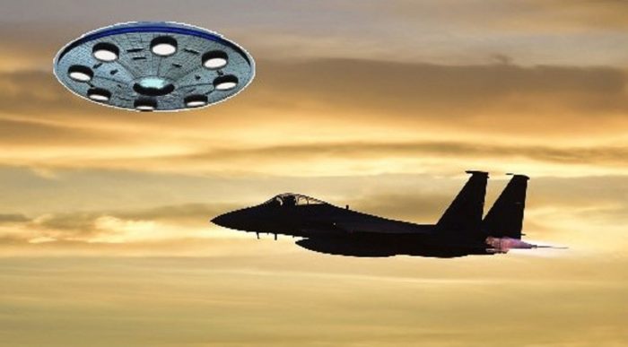 A depiction of a UFO near a military jet midair