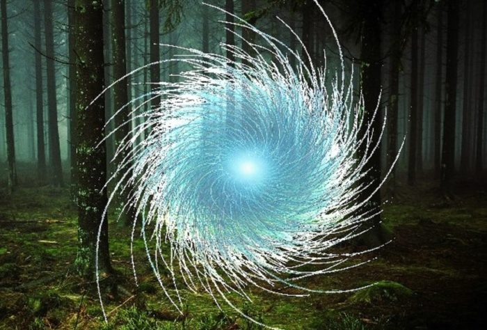 A superimposed orb over a picture of the woods at night