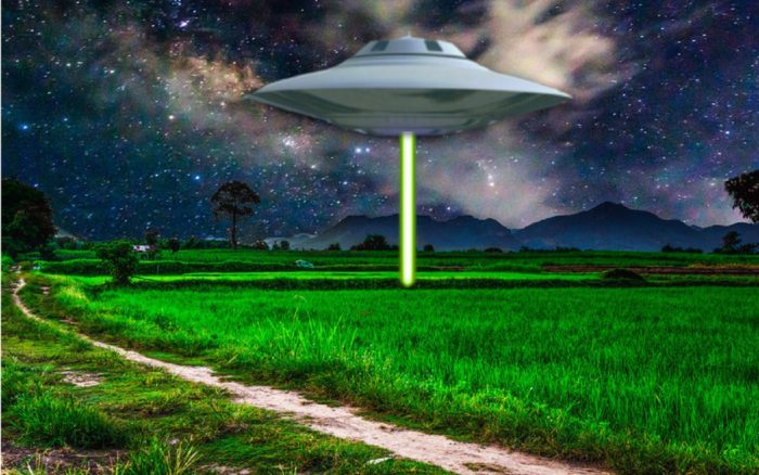 Depiction of a UFO shining a light beam to the ground 