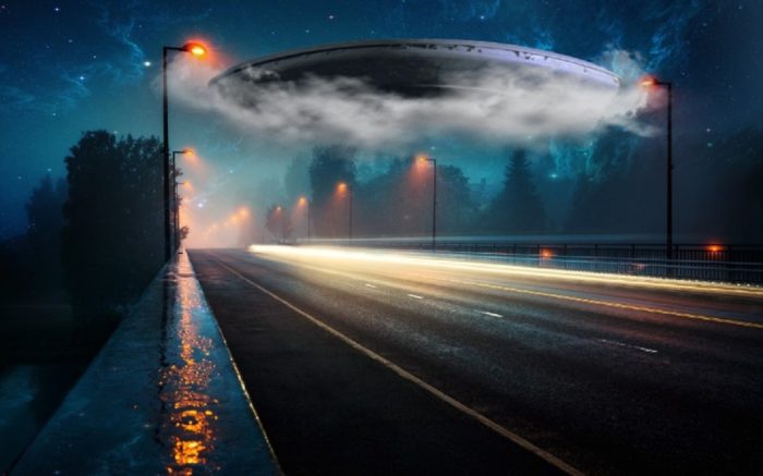 A superimposed UFO over the motorway at night