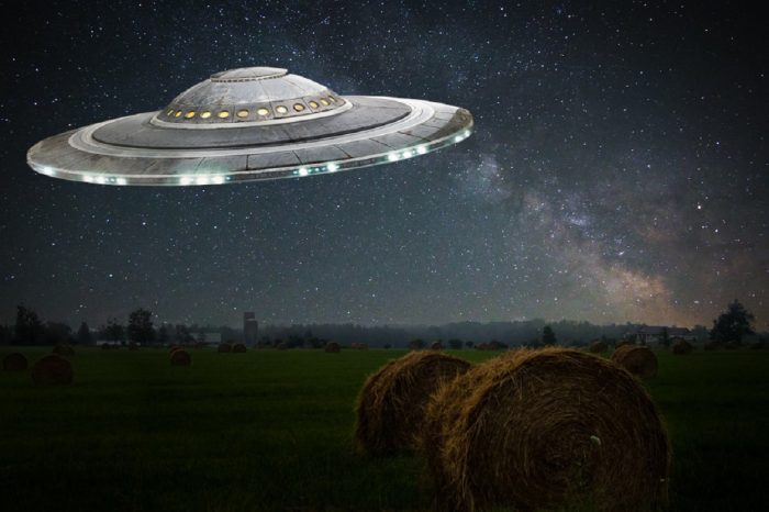 A depiction of a UFO over a farmer's field