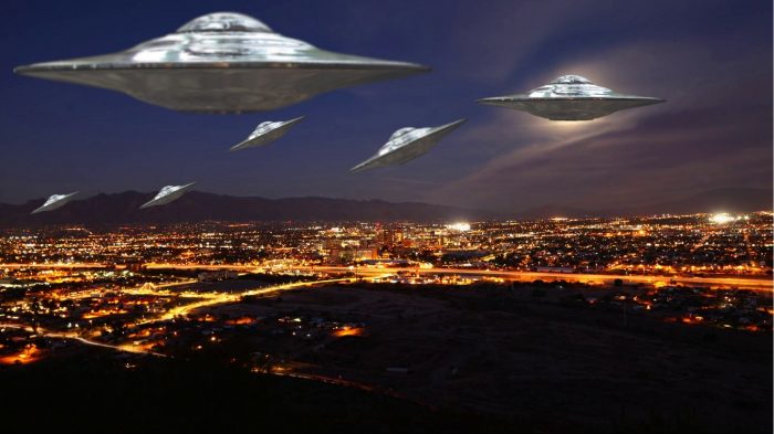 Several superimposed UFOs over an aerial night shot of Arizona 