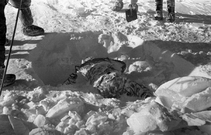 One of the dead hikers half buried in snow