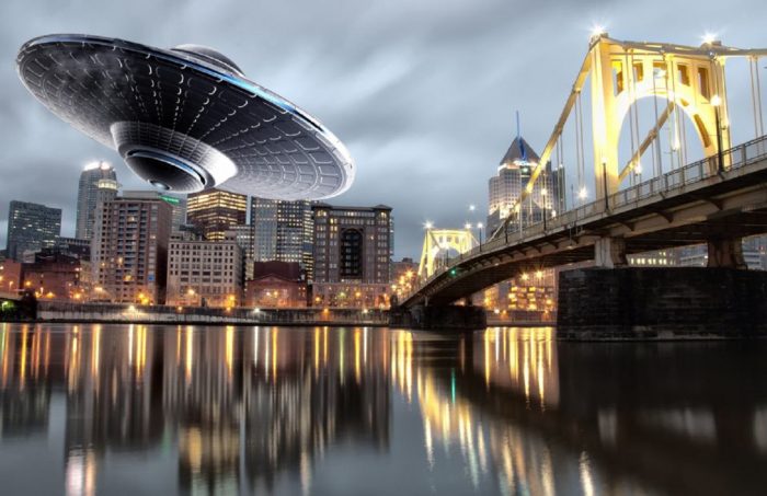 A depiction of a UFO over a river in Pittsburgh