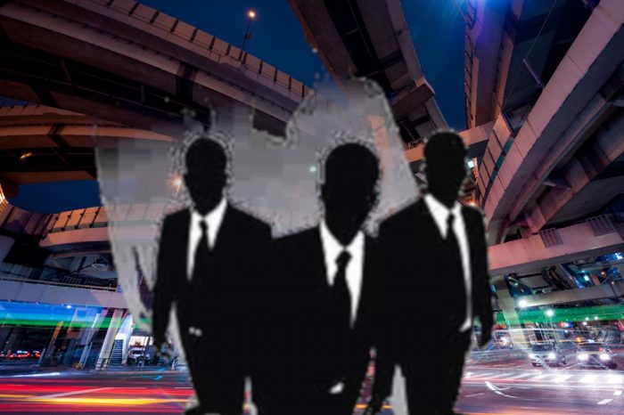 Superimposed Men In Black over a picture of Tokyo