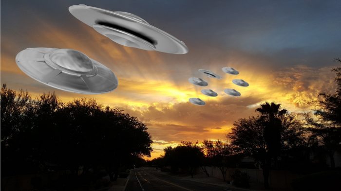 Superimposed UFOs flying in a night sky