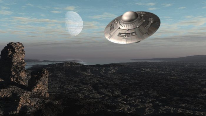 A depiction of a UFO over a mountain region