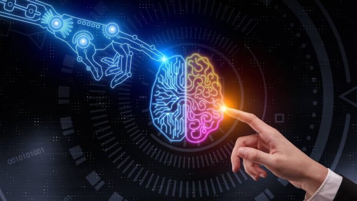 A picture of a glowing human mind with a robot finger touching one side and a human finger touching the other