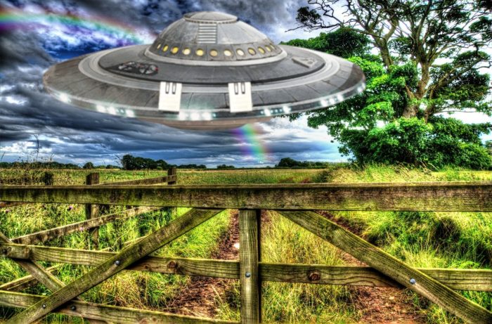 A superimposed UFO over a field in the country