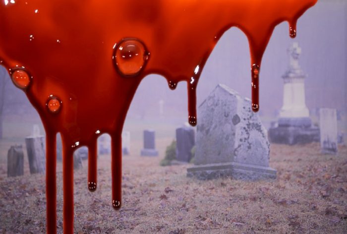 A picture of a graveyard with superimposed blood dripping down the screen