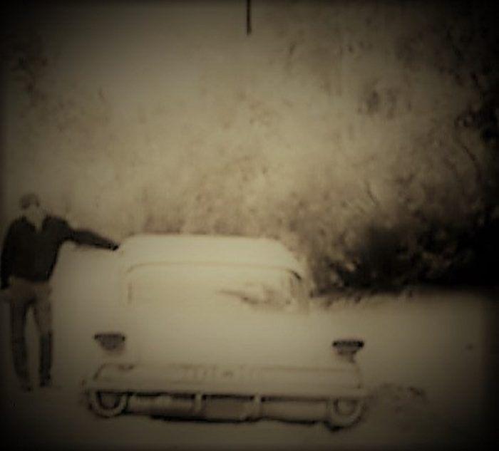 Douglas Tibbets examines his car