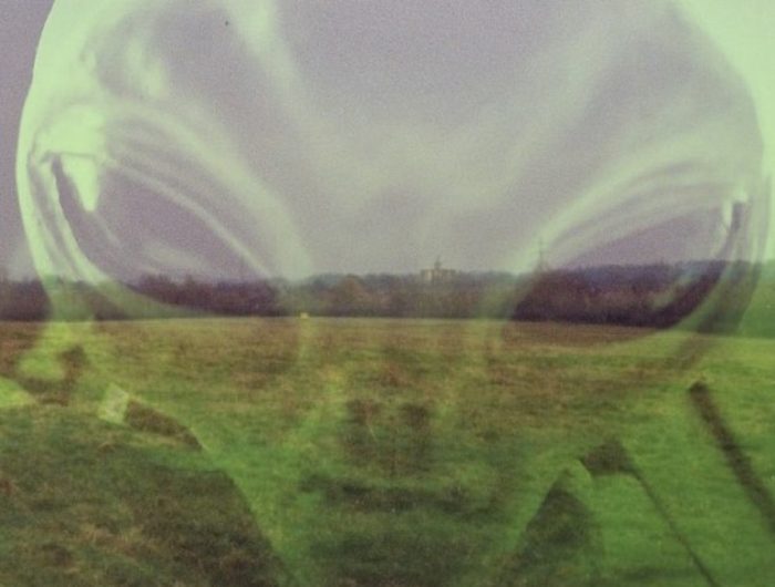 A view of the field where the incident took place with an alien head over the top