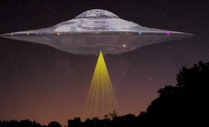 A depiction of a UFO hover over woodland at night