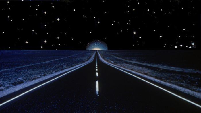 A depiction of a lonely road at night