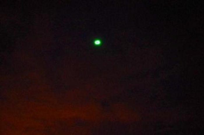 A depiction of a strange green light in the sky