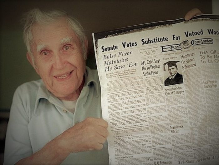 Arnold with a copy of the newspaper report of the incident 