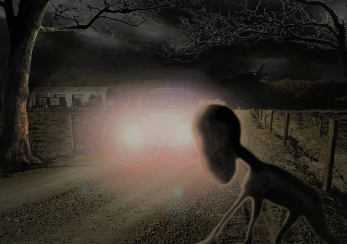 A depiction of the Dover Demon with a car approaching