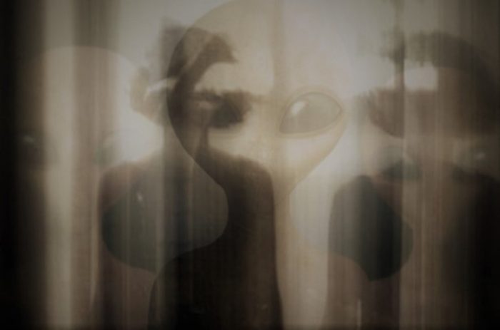 A depiction of shadow people with aliens blended over the top