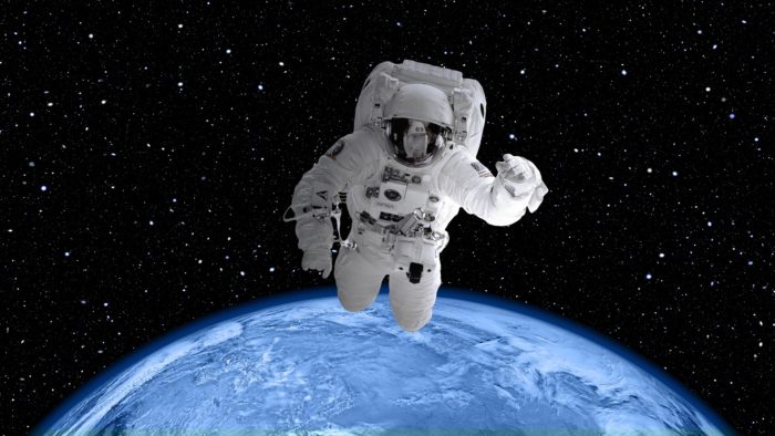 An astronaut floating high above the Earth