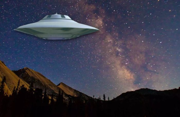 Superimposed UFO over the mountains at night