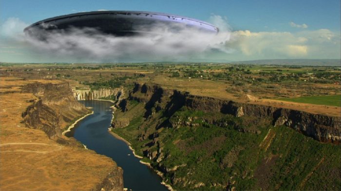 Superimposed UFO emerging from the clouds over Snake River