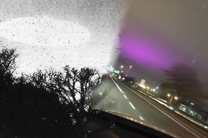 Blended image of a UFO into a view of the road from the driver's seat