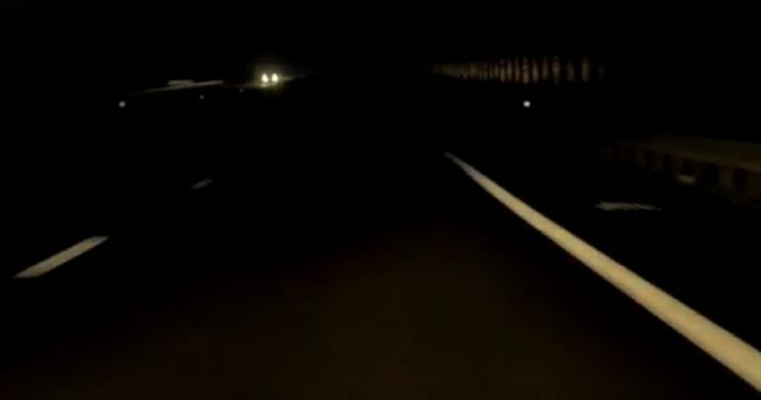 a long road stretching into the distance at night
