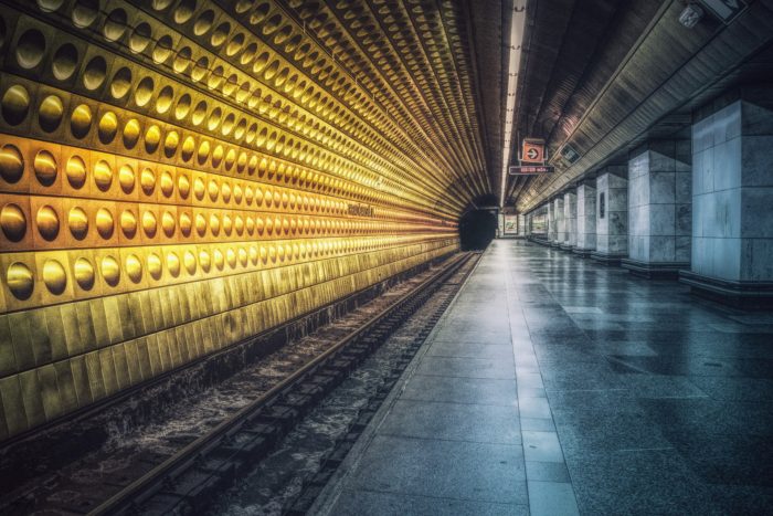 A depiction of a lonely underground rail platform