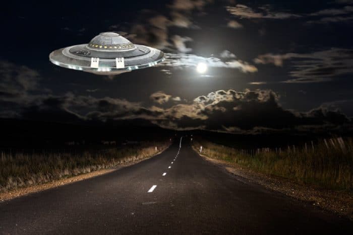 A superimposed UFO on a lonely highway