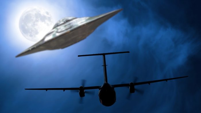 A depiction of a UFO following a plane at night