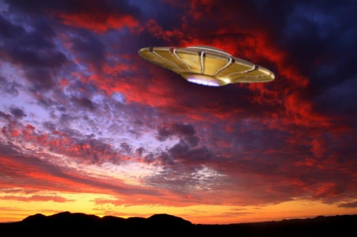 A depiction of a UFO in a sunset sky