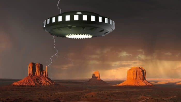 A depiction of a UFO over the desert in Arizona with a stormy sky